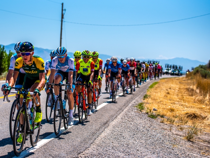 Some riders are serious in the bunch ... and some smile for the camera. Stage 1, Tour of Utah. Photo by Steven L. Sheffield