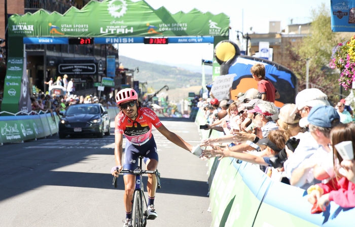 Lachlan Morton high fives the crowd.