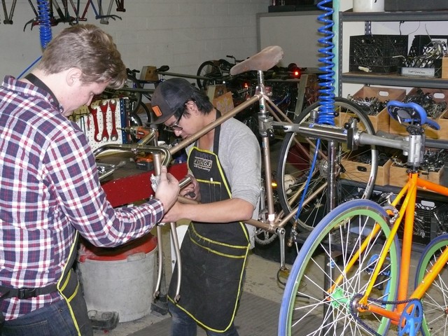 Mechanics Working On Bicycle Mechanics Working On Bicycle