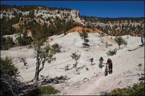 Kathleen Berglund walks with broken hand while her bike is pushed to the top.