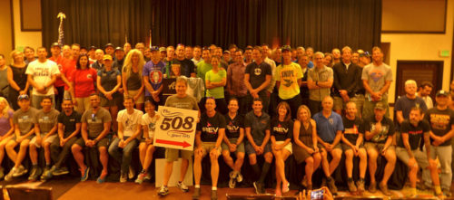 Chris Kostman is stepping down as the 508 race director. He's shown here with the group holding the sign. Photo courtesy Chris Kostman, The508.com