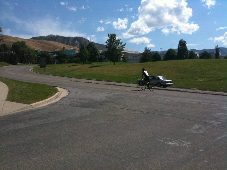 A cyclist heads the wrong way on N. Campus Drive in order to get to the University of Utah. No safe options exist. Photo by Dave Iltis