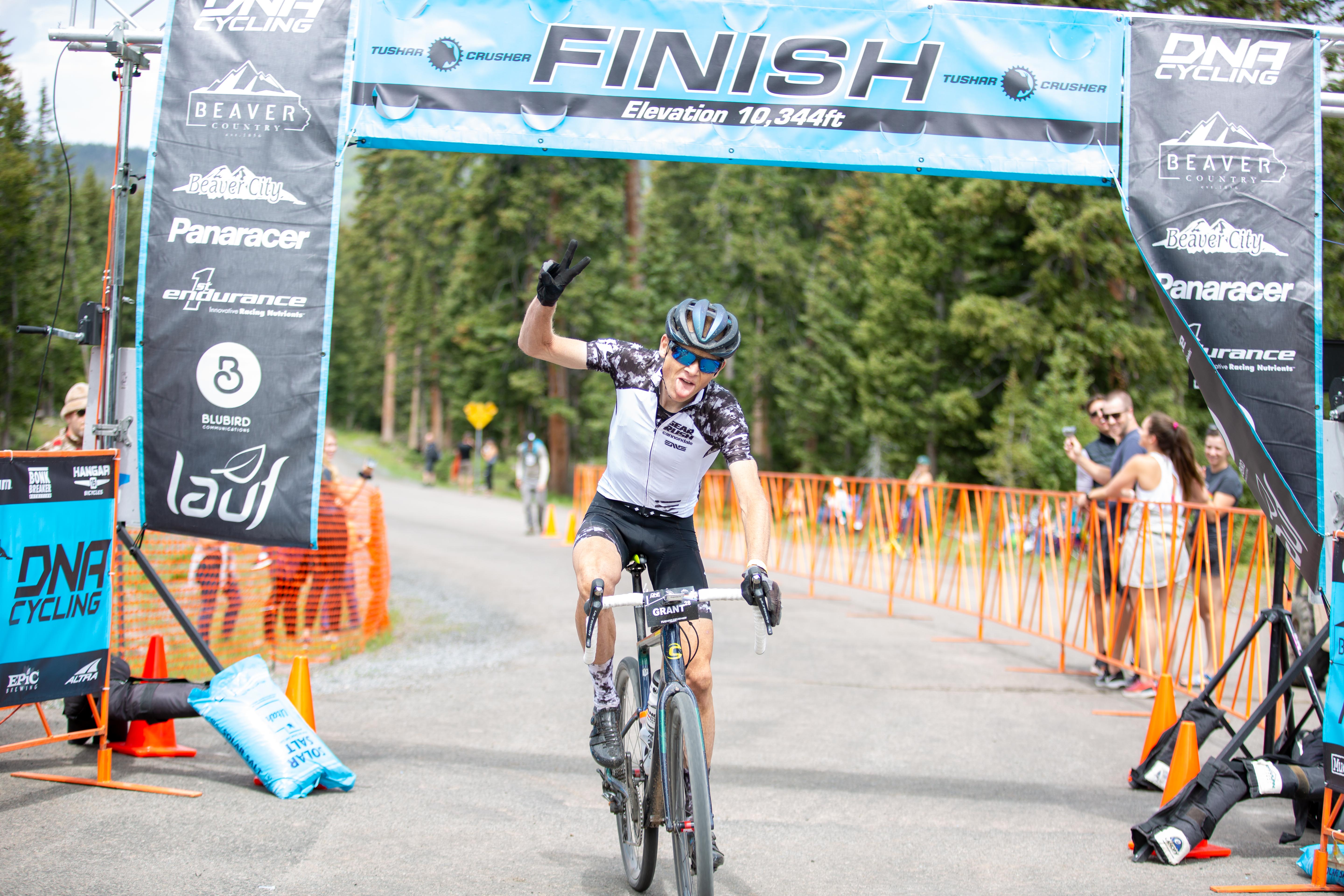 Alex Grant crosses the line officially, after originally going up the wrong side of the fencing and having to backtrack. Photo by Angie Harker.