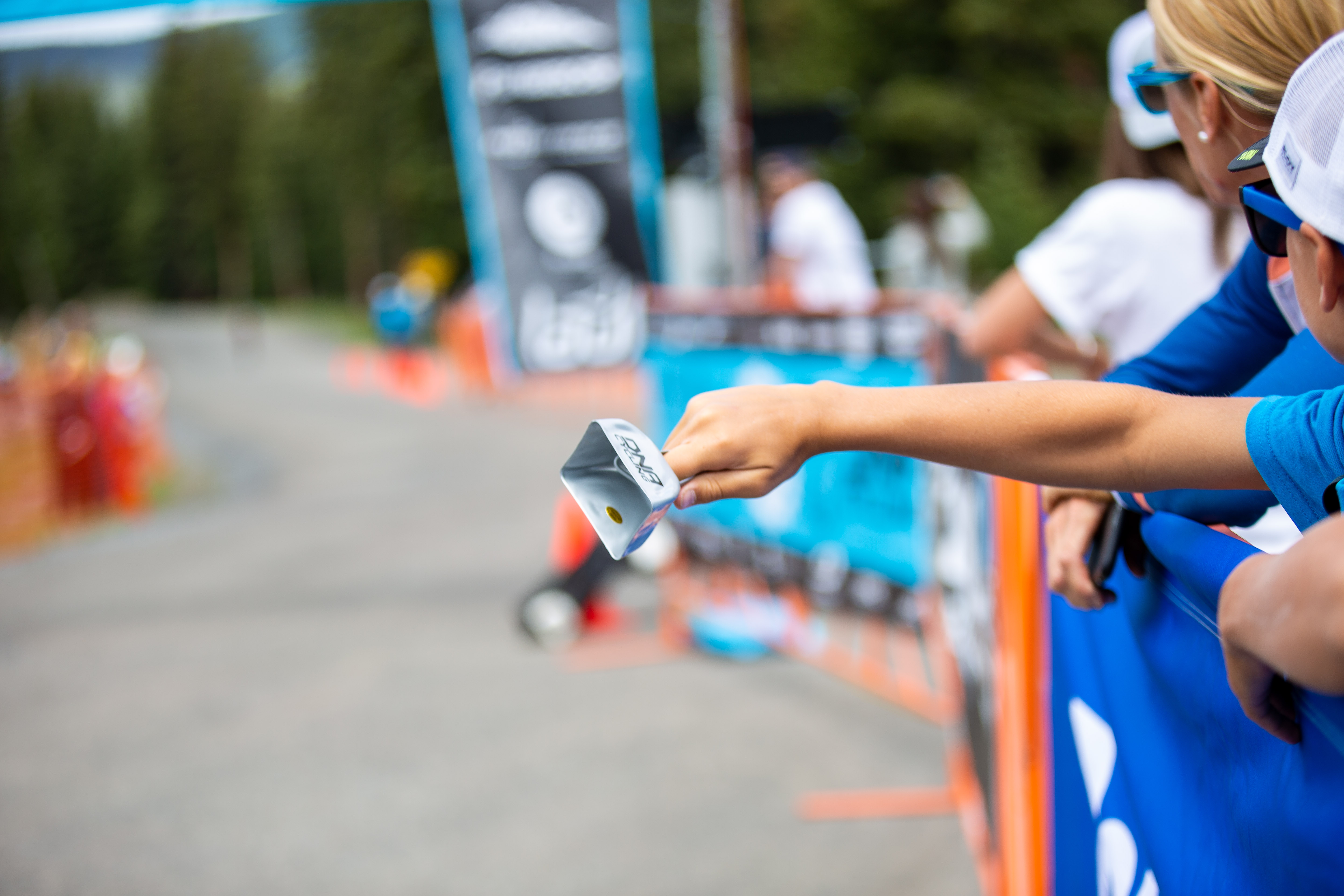 A young fan rings a cowbell at the finish line. Photo: Angie Harker.