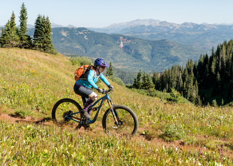 My wife Jenni, pedaling at nearly 12,000 feet, on Kennebec Pass, the southern end of the Colorado Trail. Photo by John Shafer, photo-john.net