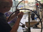 A man repairs part of a wheel on his bicycle. Photo by James Knight