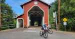 Cyclists emerge from the Office Covered Bridge in Westfir. Photo by Dan Shryock