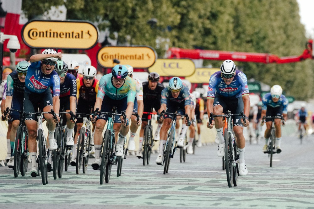 Mathieu Van der Poel (right) won stage 21 with an incredible last kilometer effort to hold off the charging peloton. Teammate Jasper Philipsen (left with hand up) took second and Green Jersey winner Mads Pedersen took third. Photo: © A.S.O / Thomas Maheux